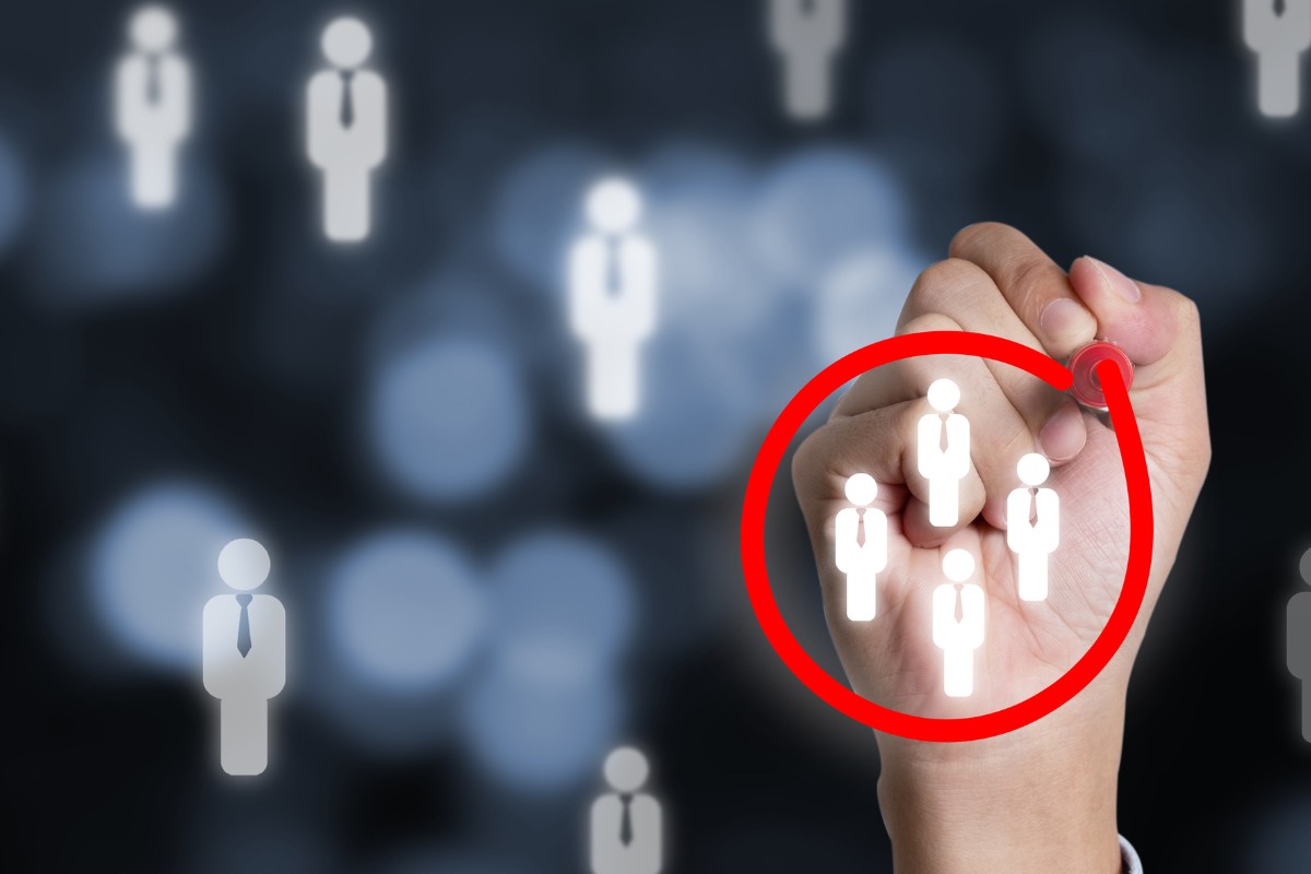 A hand circling a group of job candidates with a red pen