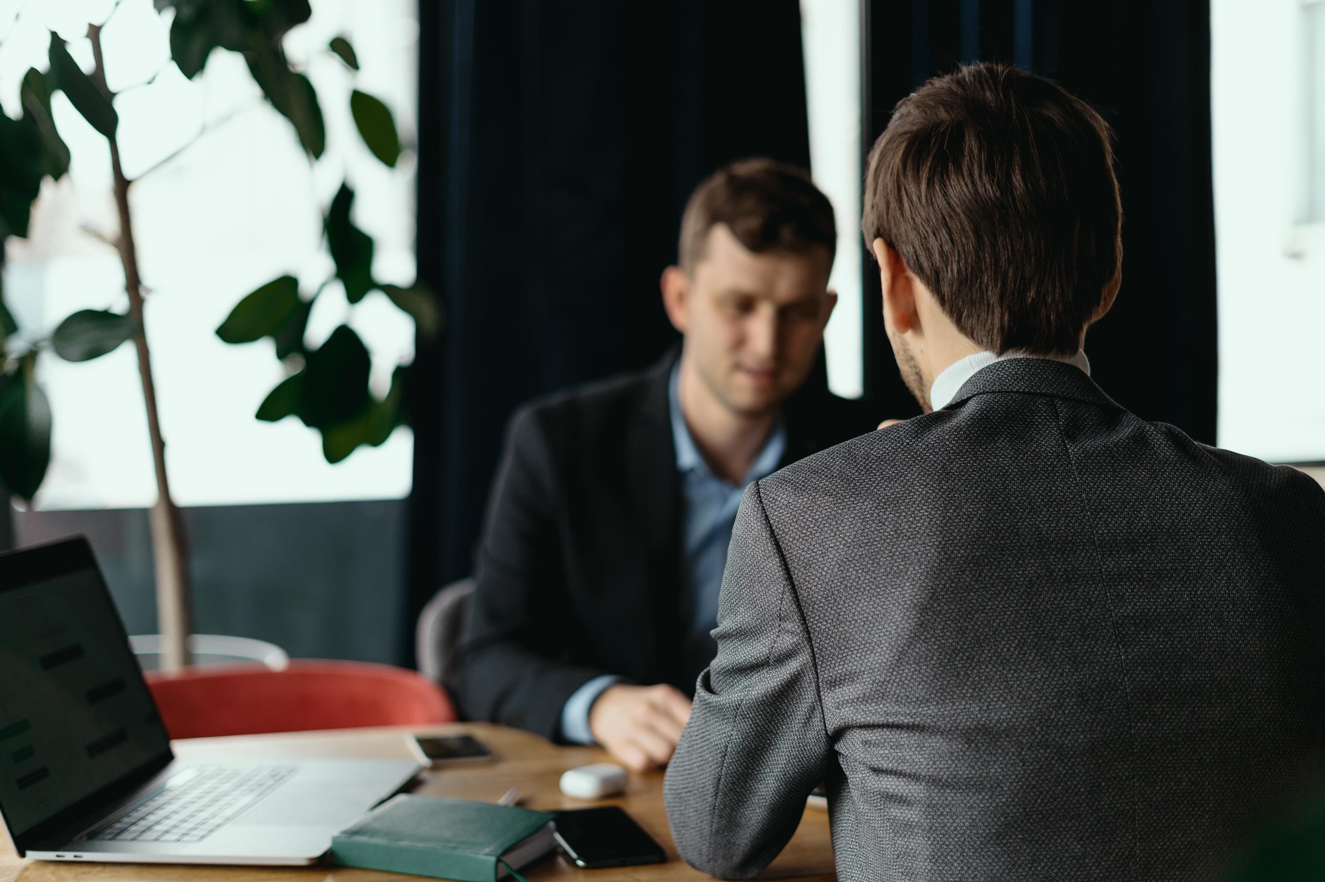employee sitting at a desk with their boss