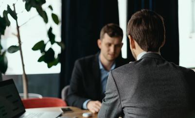 employee sitting at a desk with their boss